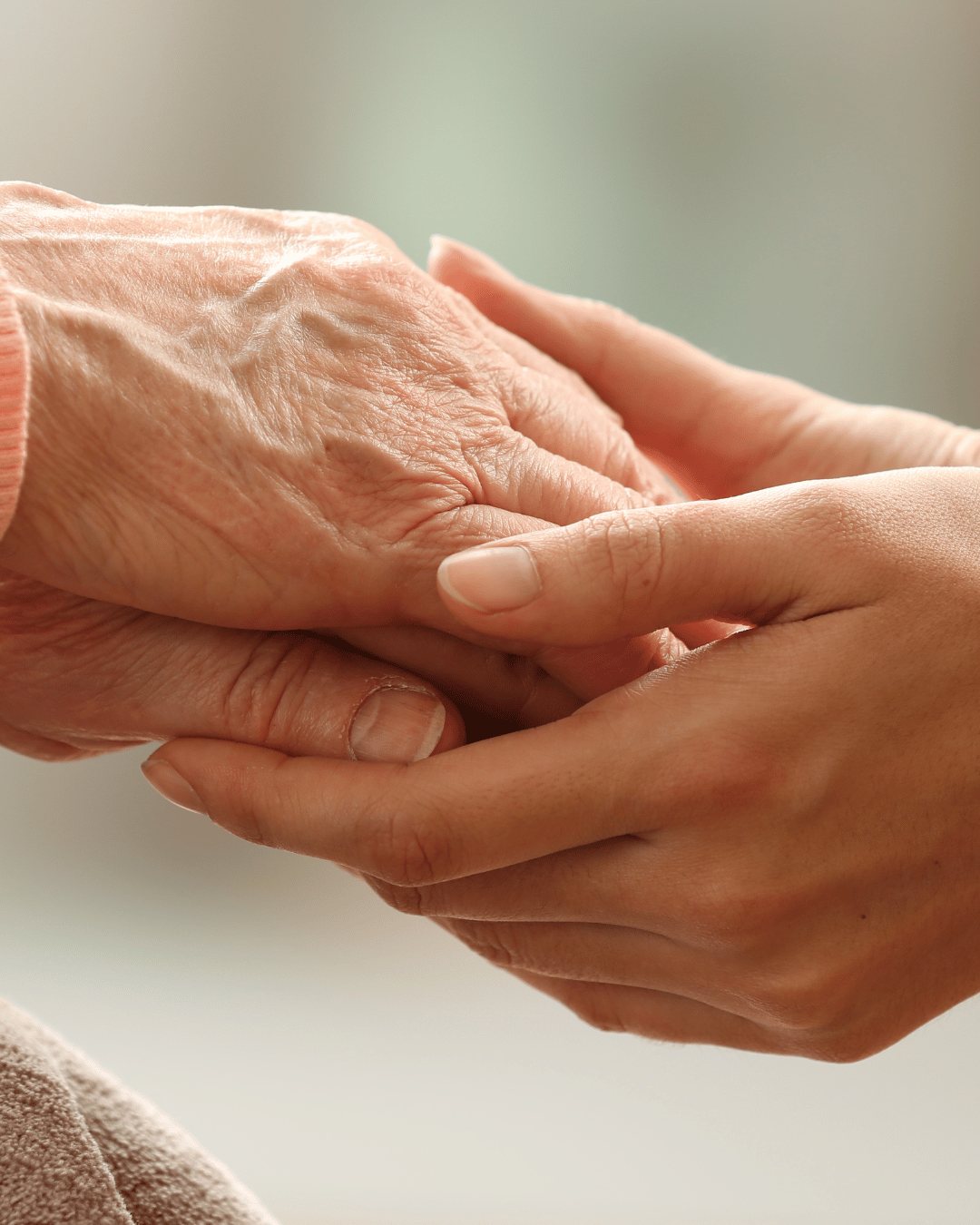 old and young hands together